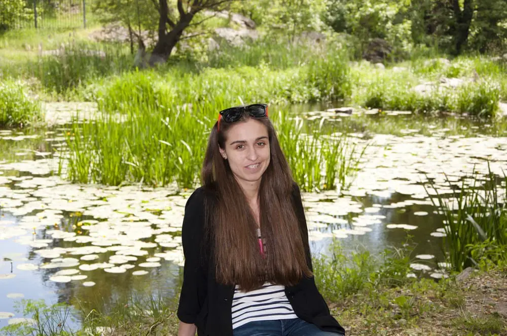girl with long hair outdoor. spring nature. blooming lilly flower on lake water. river water. summer pond. relax in park or forest